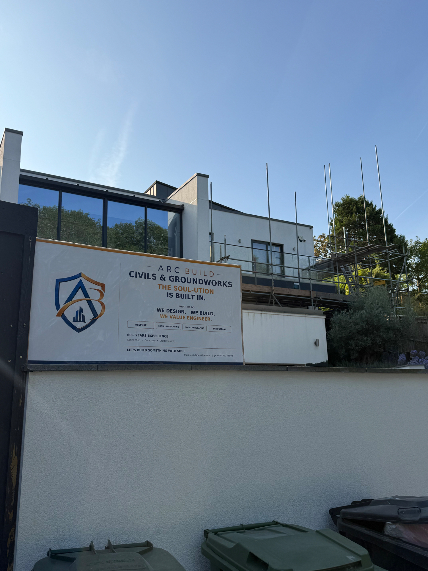 A.R.C Build site signboard mounted at a modern residential project with scaffolding