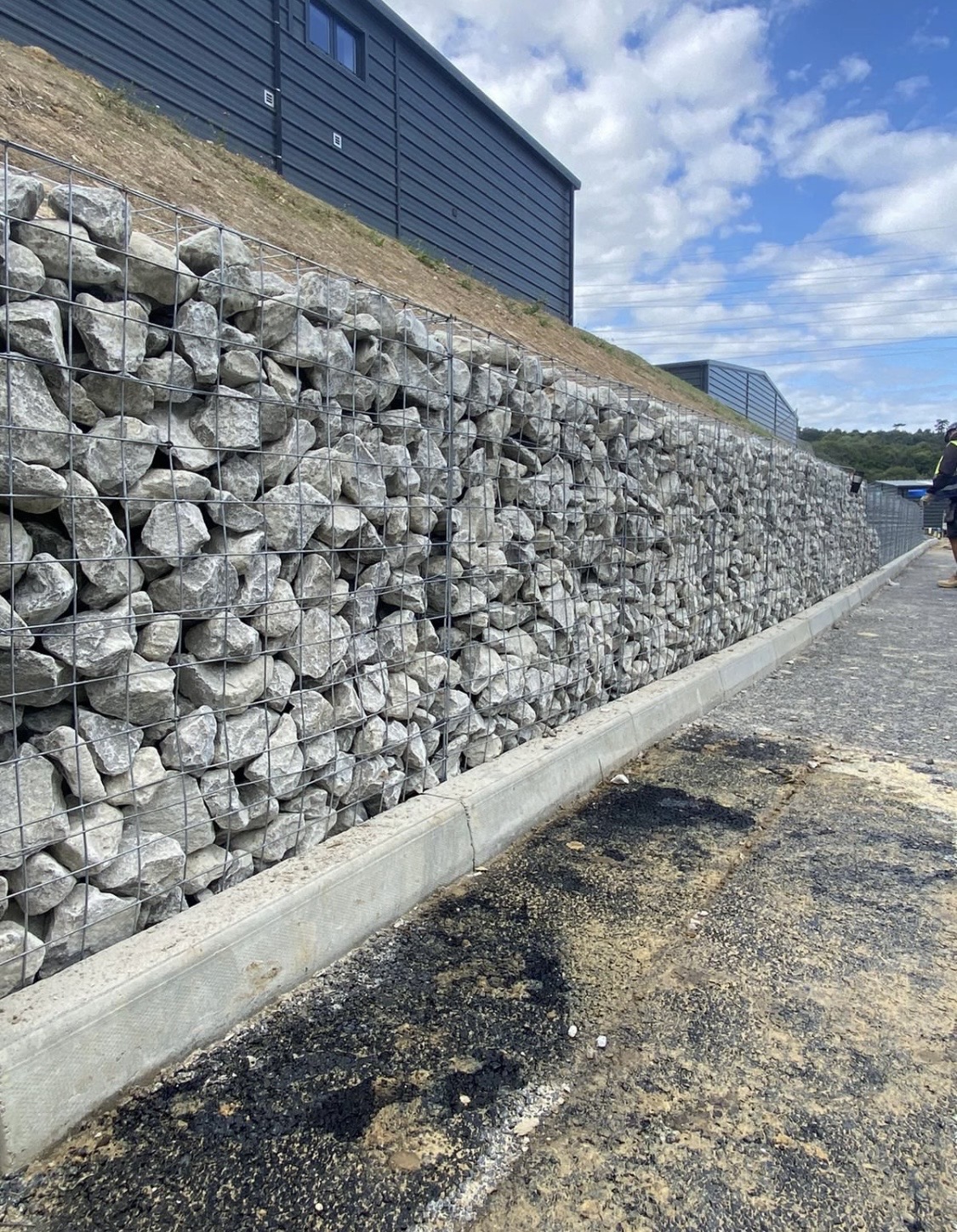 Gabion retaining wall beside a newly finished commercial yard