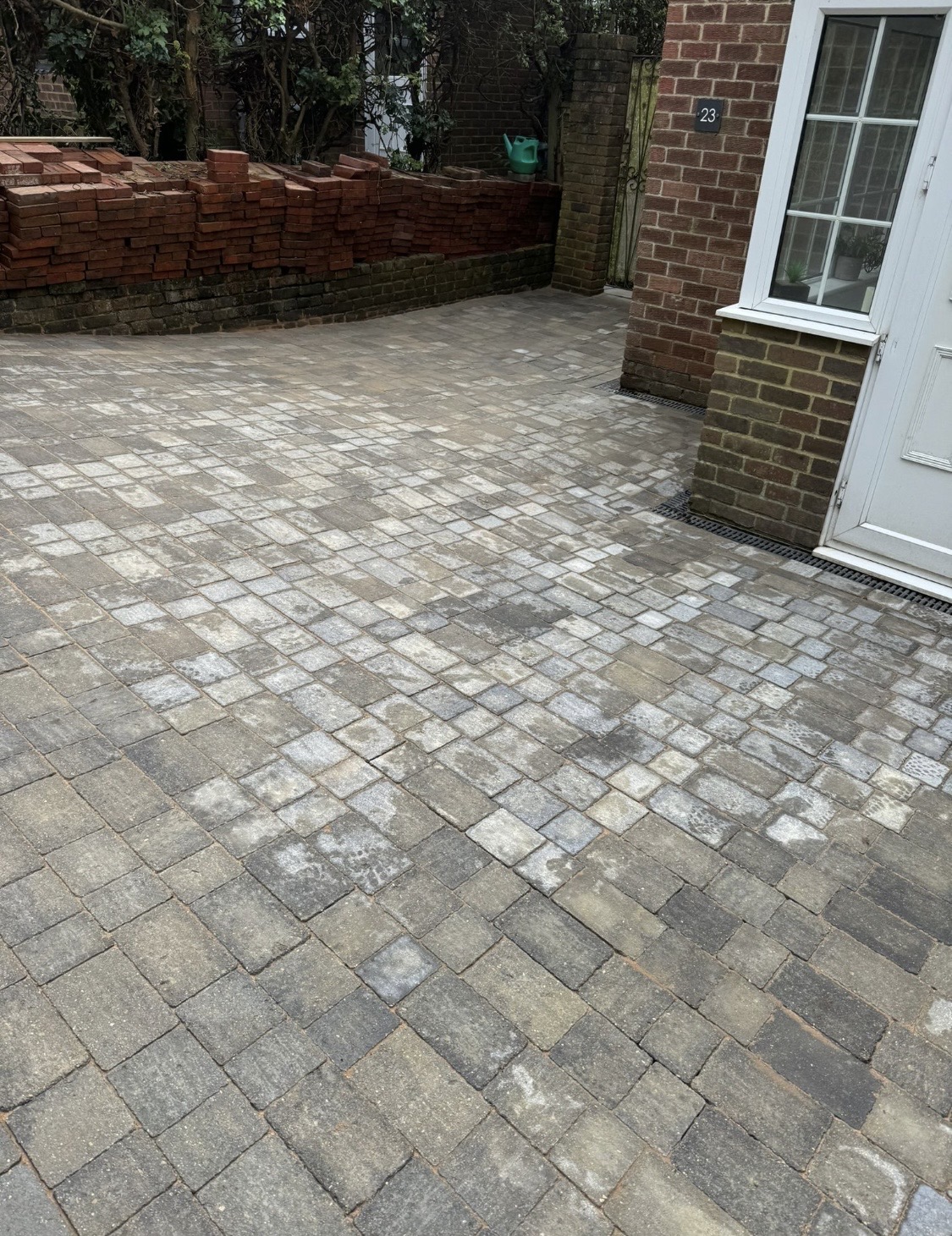 Freshly laid block paving driveway outside a brick house
